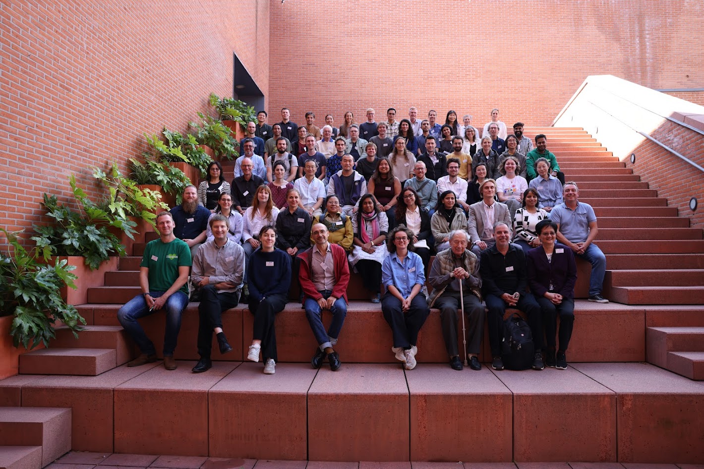 Group photo of the Agrobacterium 2025 attendees on the steps in Leuven